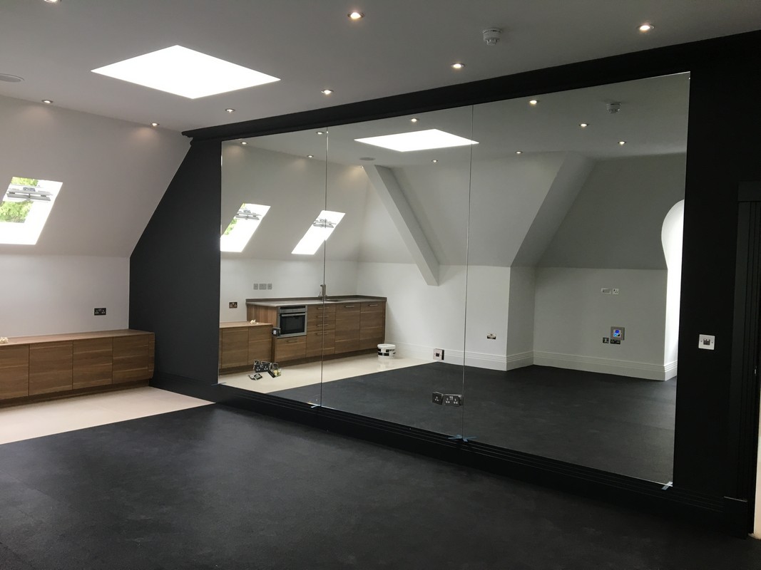 Frameless glass wall dividing loft conversion in Bermondsey
